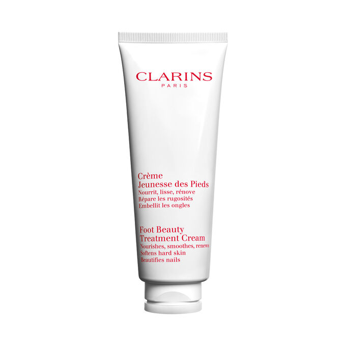 Packshot av en flaska med Clarins Foot Beauty Treatment Cream, n&auml;ra n&aring;gra shean&ouml;tter mot en vit bakgrund.