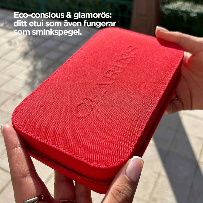 Närbild på etuiet, som visar dess röda design och spegelen.