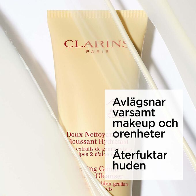Packshot av den gula tuben med Clarins &aring;terfuktande l&ouml;ddrande ansiktsreng&ouml;ring under skum med text om dess lugnande effekt.